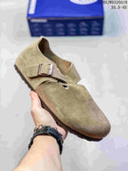 Olive-tan closed-toe sandal with two buckle straps; size range text appears in the image.