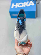 Front view showing the black laces, blue tongue detail, gray mesh toe box, and blue toe outsole accent.
