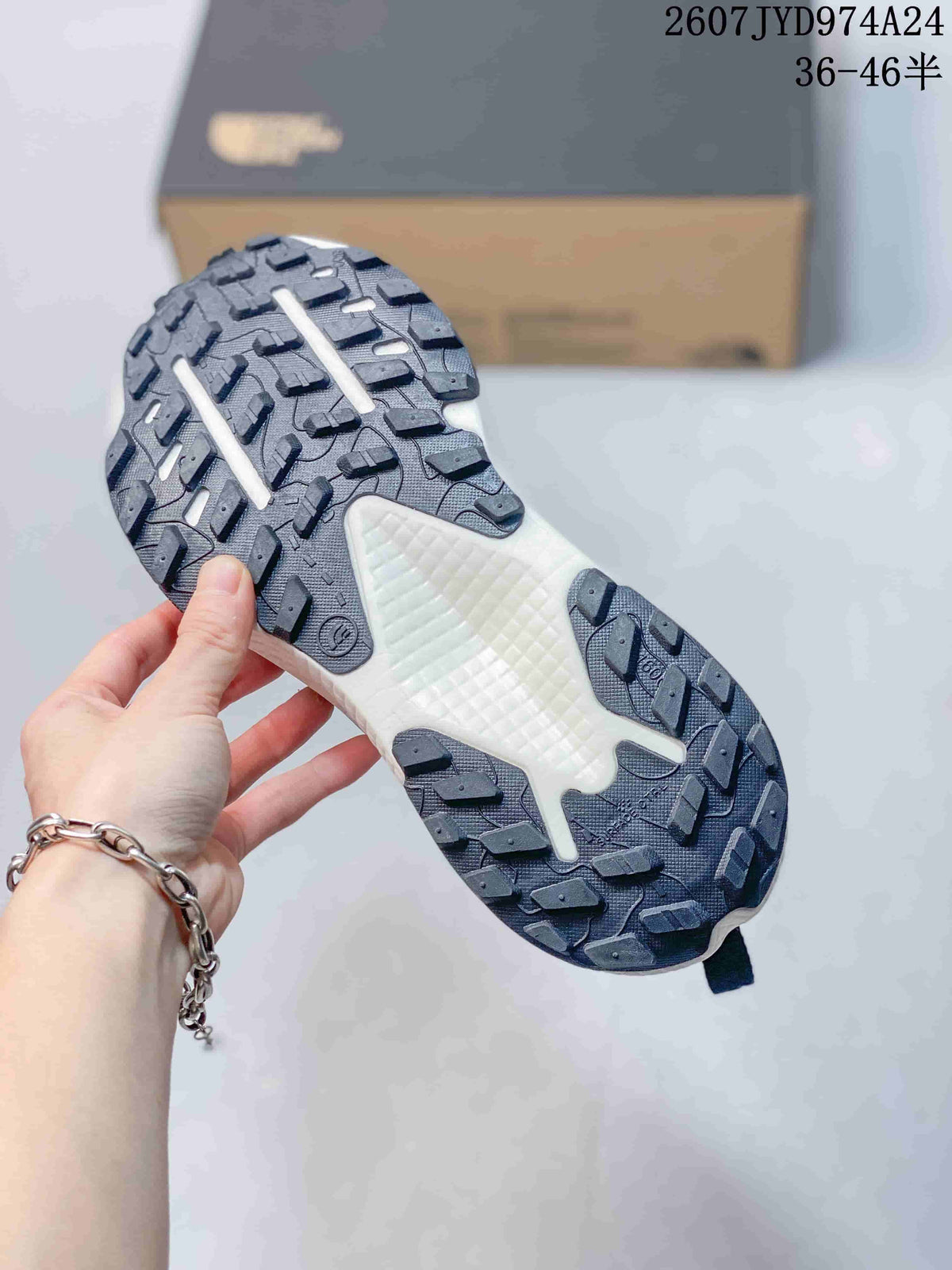 Underside view of the sneaker showing a black lugged outsole and white textured midfoot section.