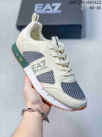 Close-up of a cream EA7 sneaker showing the side logo panel, dark textured inserts and lace-up front.