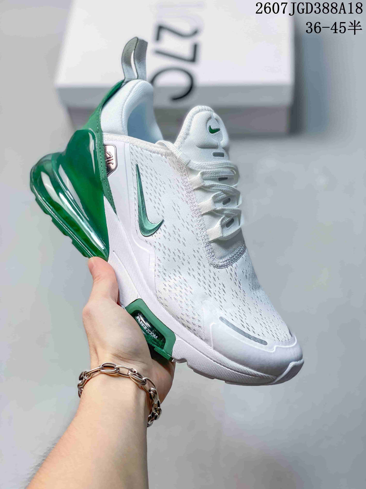 White Nike Air Max 270 Premium sneaker with green accents and a visible green heel air unit.