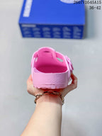 Rear view of a pink sandal showing the heel area, textured sidewall and outsole edge.