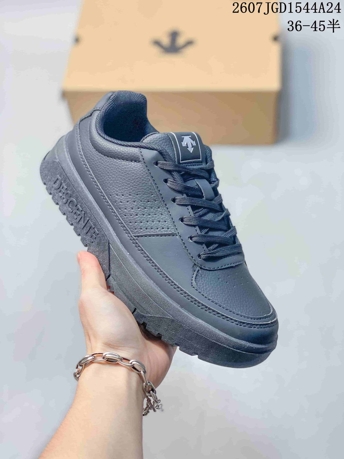 Side view of a navy DESCENTE Dualis sneaker showing perforated panels and raised branding on the midsole.