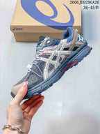 Side view highlighting the ASICS branding, mesh panels, layered overlays and rugged outsole.