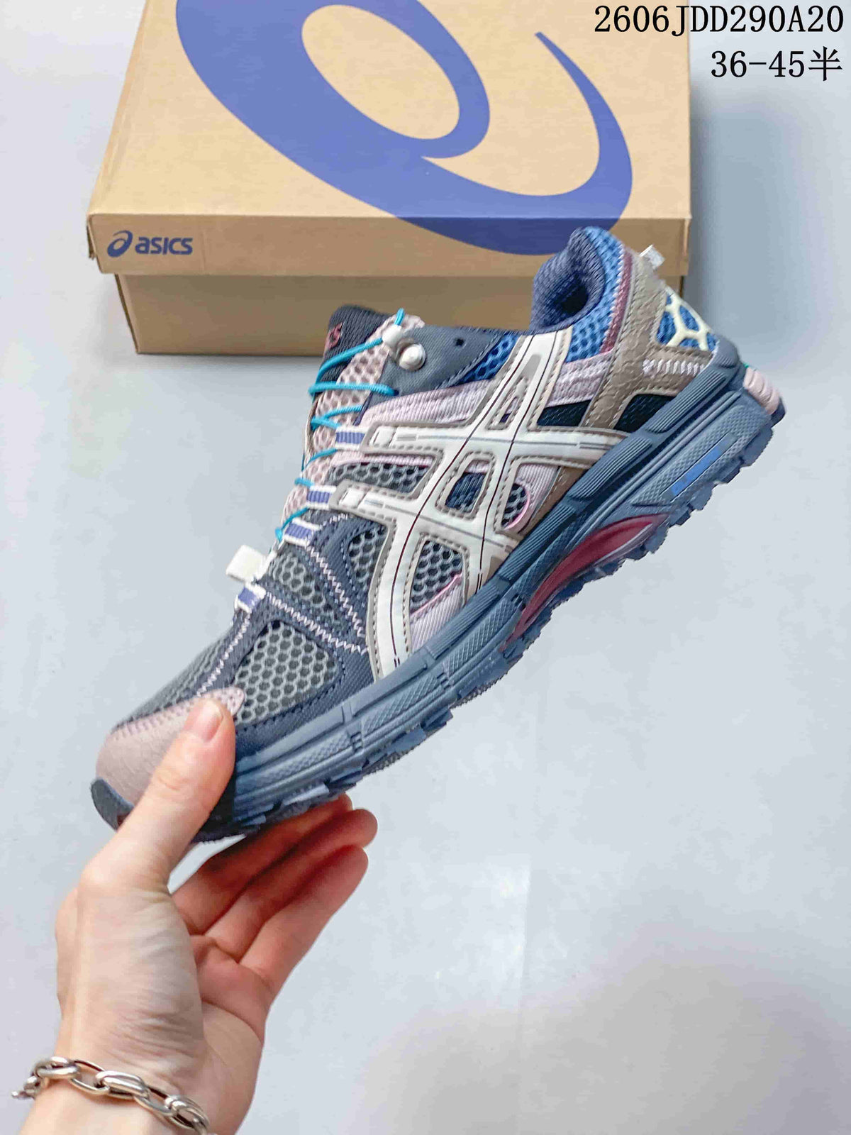 Side view highlighting the ASICS branding, mesh panels, layered overlays and rugged outsole.