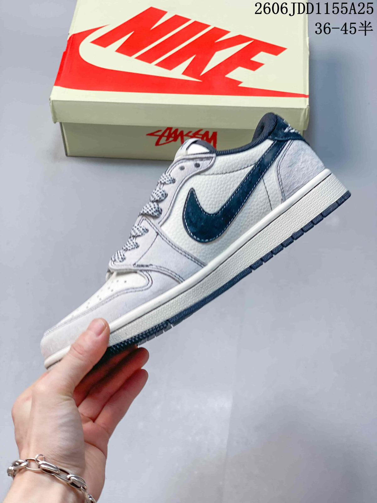 Side profile highlighting the white upper, navy Swoosh overlay, light gray panels, and layered low-top construction.