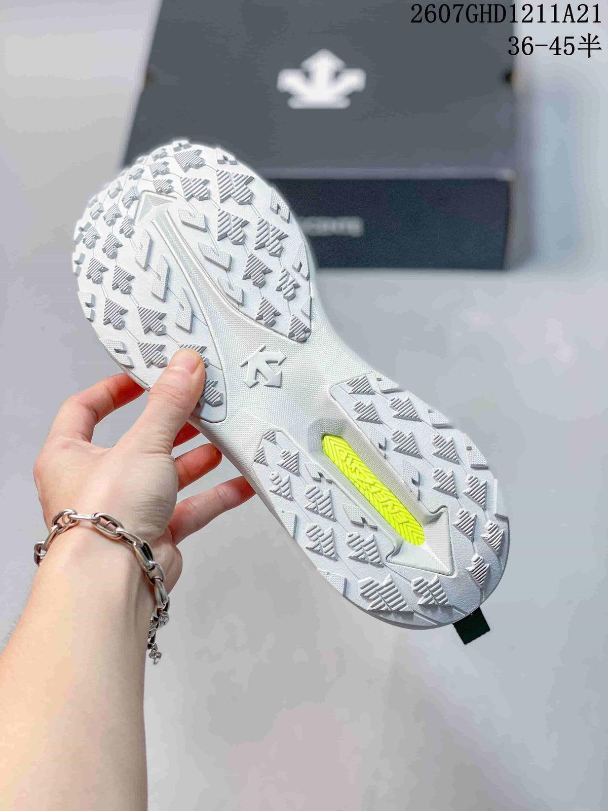 Underside view of the sneaker showing the raised patterned outsole and lime-green insert.