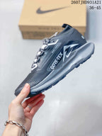 Side view of the trail sneaker showing Nike branding, GORE-TEX marking, layered panels, and a gray midsole.