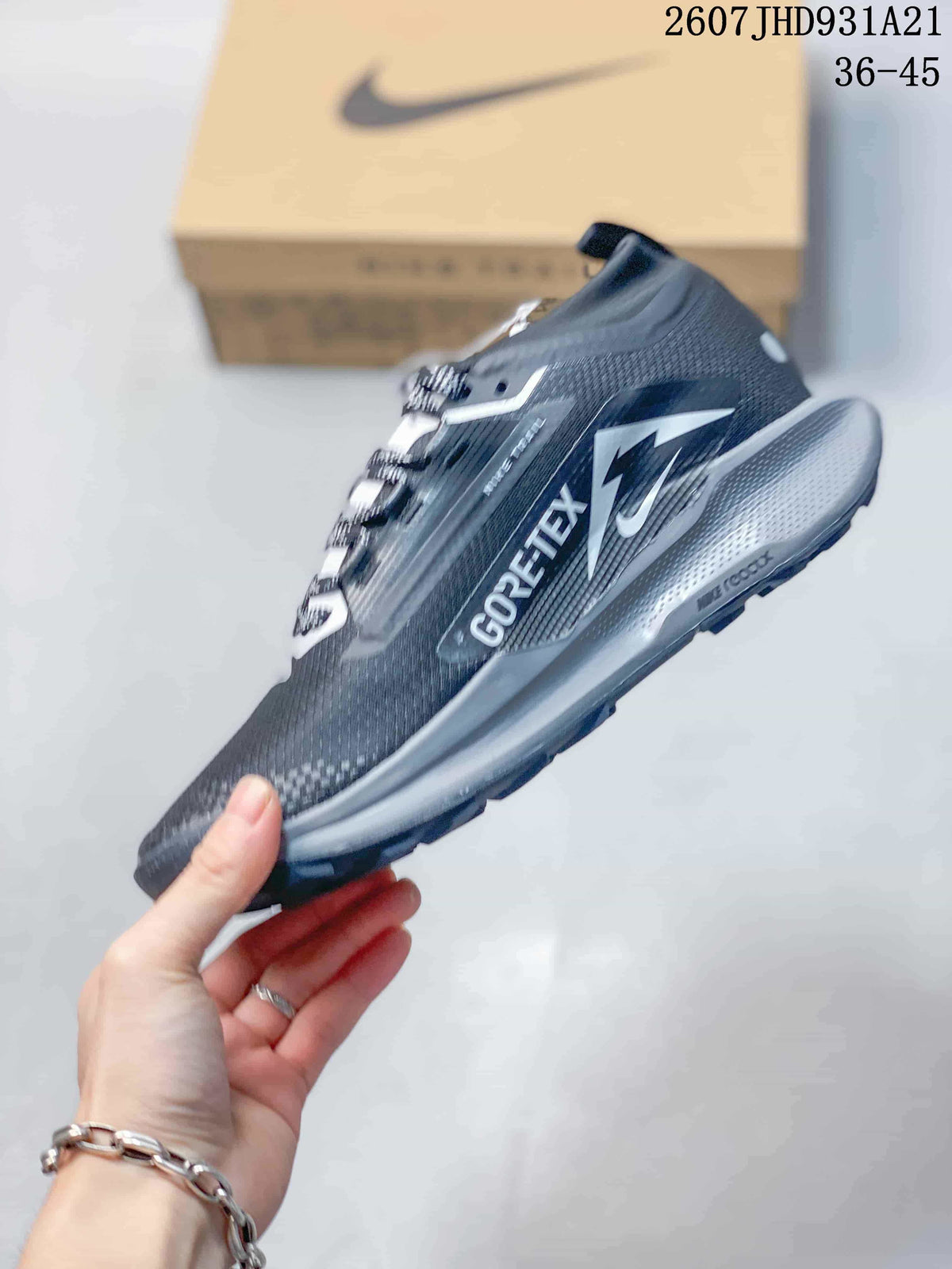 Side view of the trail sneaker showing Nike branding, GORE-TEX marking, layered panels, and a gray midsole.