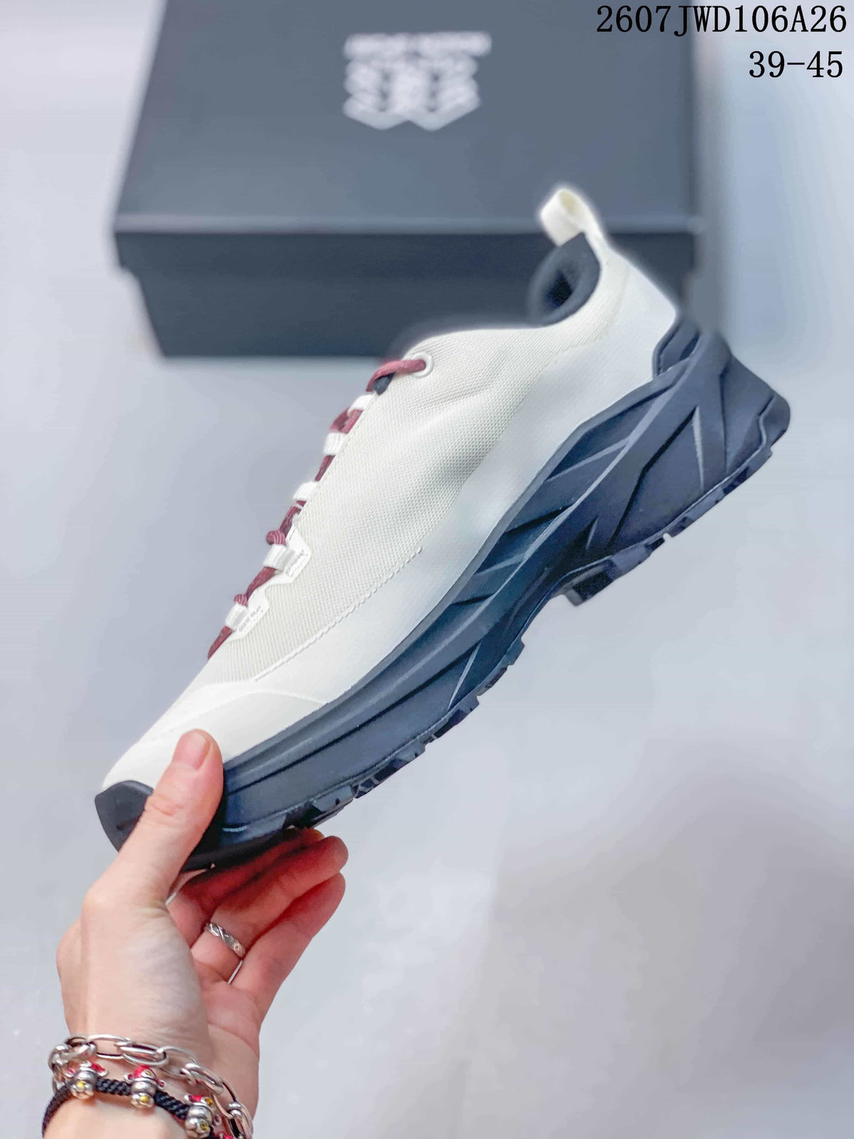 Side view of the white hiking shoe showing the black sole unit, heel structure and textured upper.