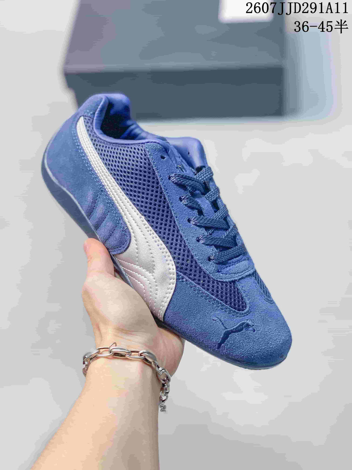 Blue PUMA sneaker with a contrasting light side stripe, lace-up front, and textured panels.