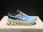 Single side view of the Cloudmonster 1 sneaker showing the light blue upper, dark heel panel, and white sole.