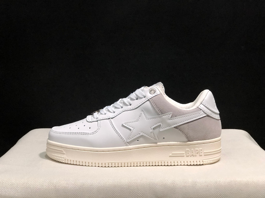 Side profile showing the white sneaker upper, gray heel panel, star side detail, and layered rubber sole.