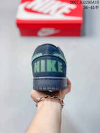 Rear view of the sneaker showing mint-green heel branding, padded collar, and dark rubber sole.