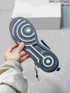 Close view of the sneaker outsole showing concentric traction patterns and a central Nike mark.