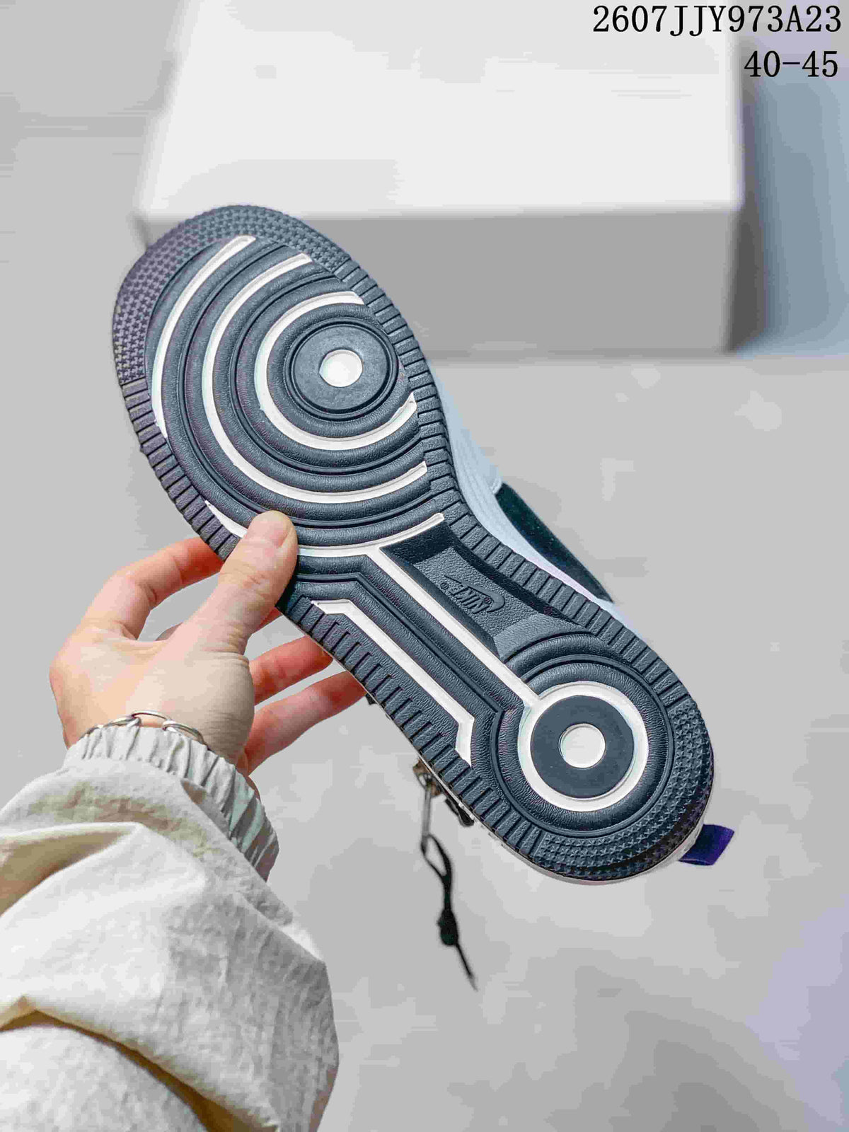 Close view of the sneaker outsole showing concentric traction patterns and a central Nike mark.