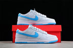 Side view of a sneaker positioned above a red shoebox, showing the bright blue Swoosh, gray and white upper, and blue outsole.
