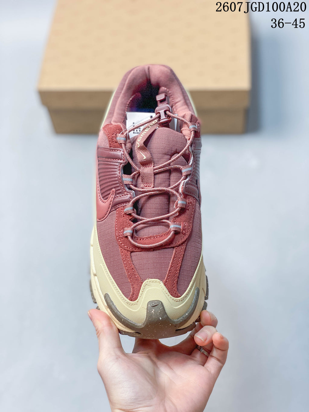 Top view showing the burgundy mesh-like upper, layered overlays, laces, and toggle-style detail.