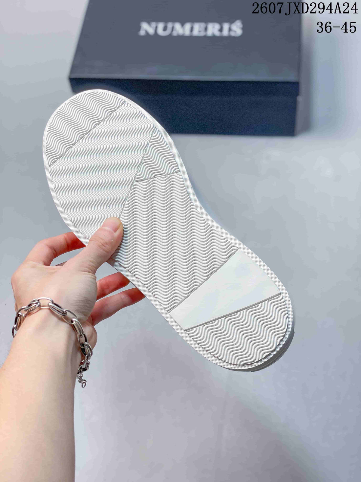Underside of the sneaker showing a white textured rubber outsole with a wavy tread pattern