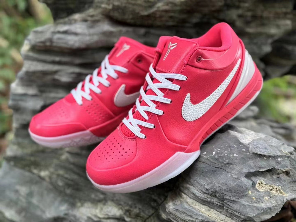 Close view of the pink Nike Kobe 4 shoes with white laces and side details.