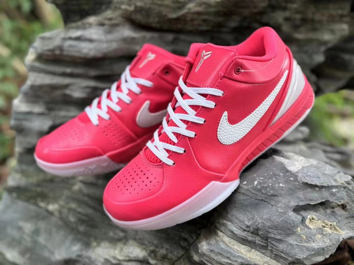 Close view of the pink Nike Kobe 4 shoes with white laces and side details.
