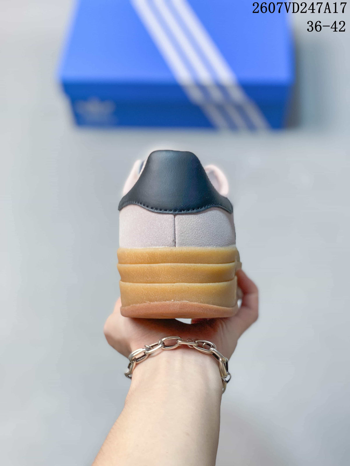 Rear view showing the black heel accents and layered gum-colored platform sole.