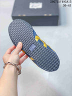 Underside view of a blue and yellow sneaker showing the circular-pattern textured outsole and central brand detail; image text shows size range 36-45.