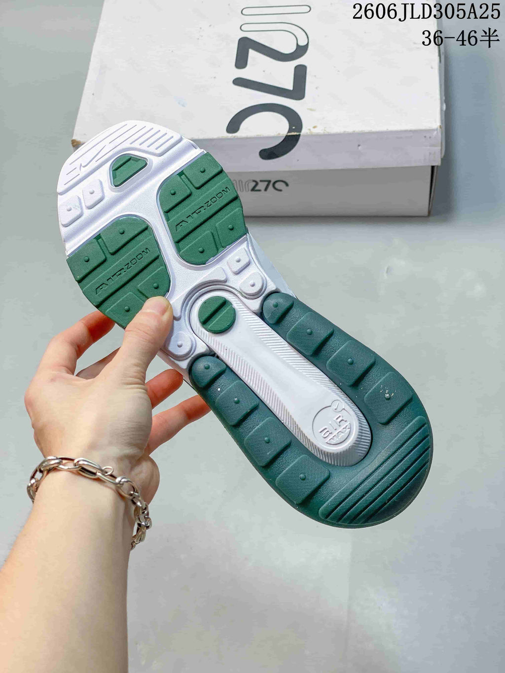 Outsole of the white and green sneakers with dark green tread sections