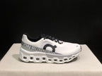 Side profile of a white On Cloudmonster 2 shoe