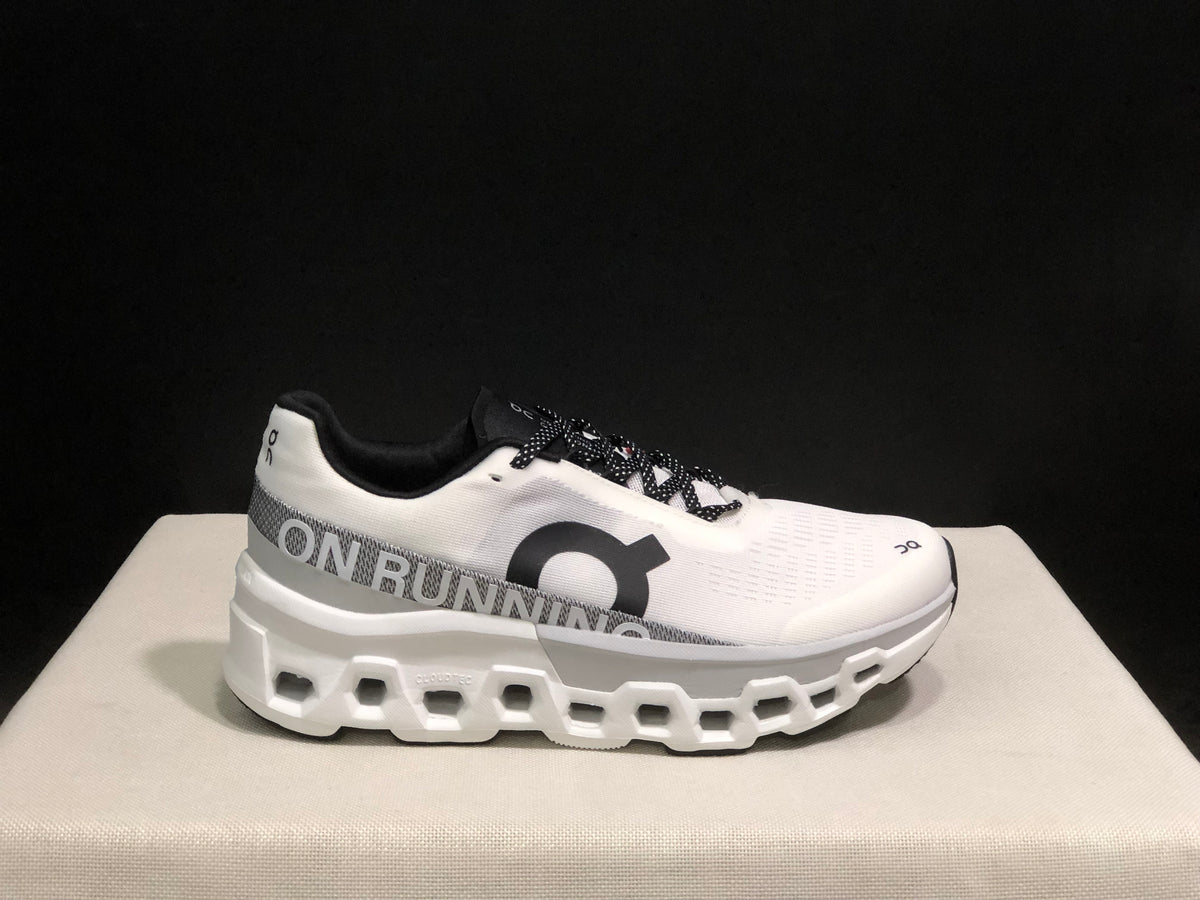 Side profile of a white On Cloudmonster 2 shoe