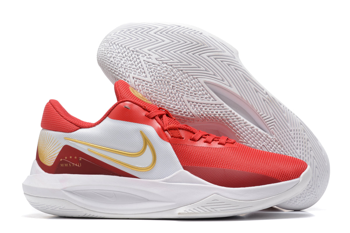 Red and white basketball shoe with gold-colored accents.