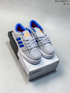 Pair of grey and blue Adidas GVP Canvas Str sneakers displayed on an Adidas shoebox.