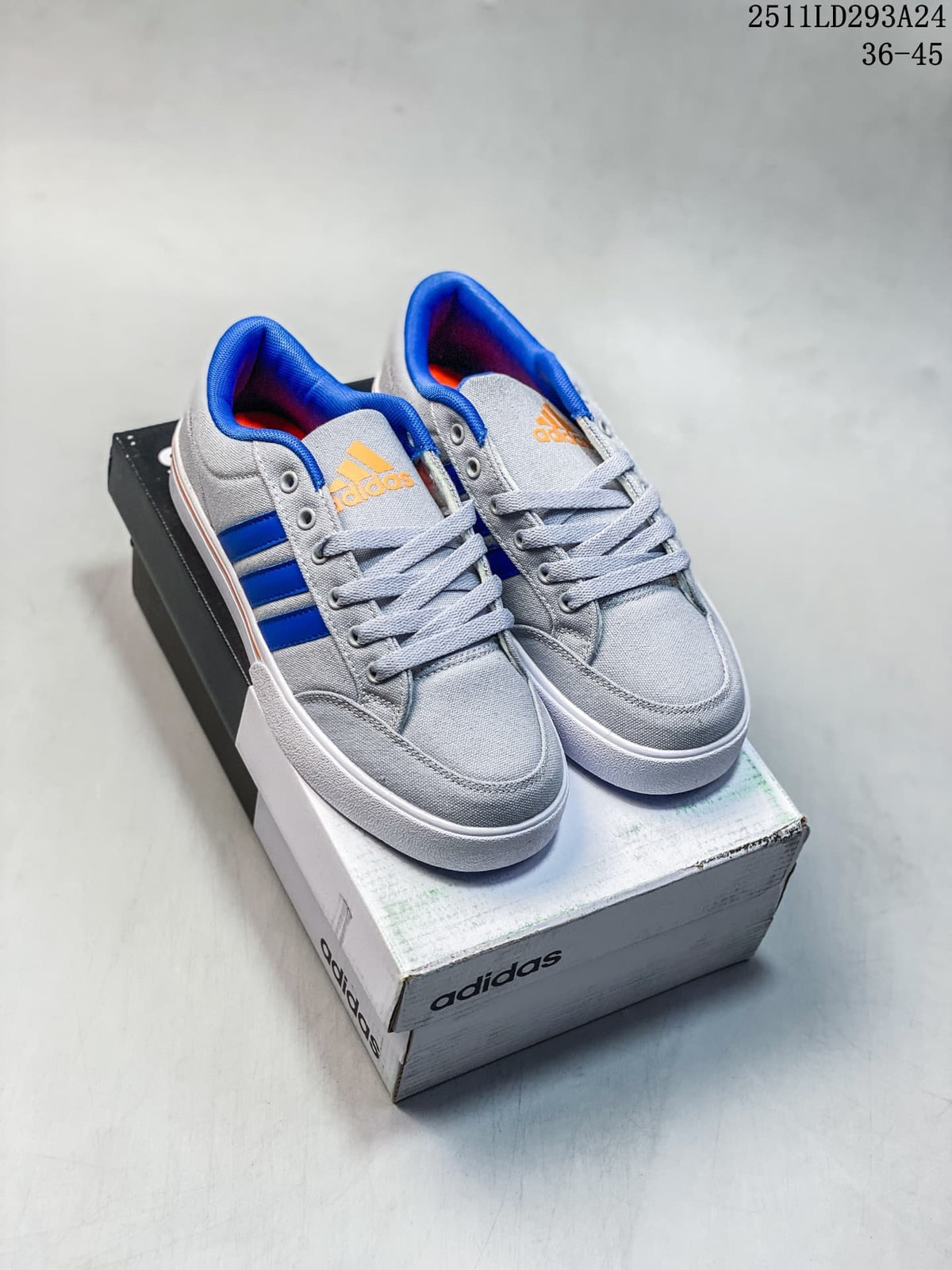Pair of grey and blue Adidas GVP Canvas Str sneakers displayed on an Adidas shoebox.