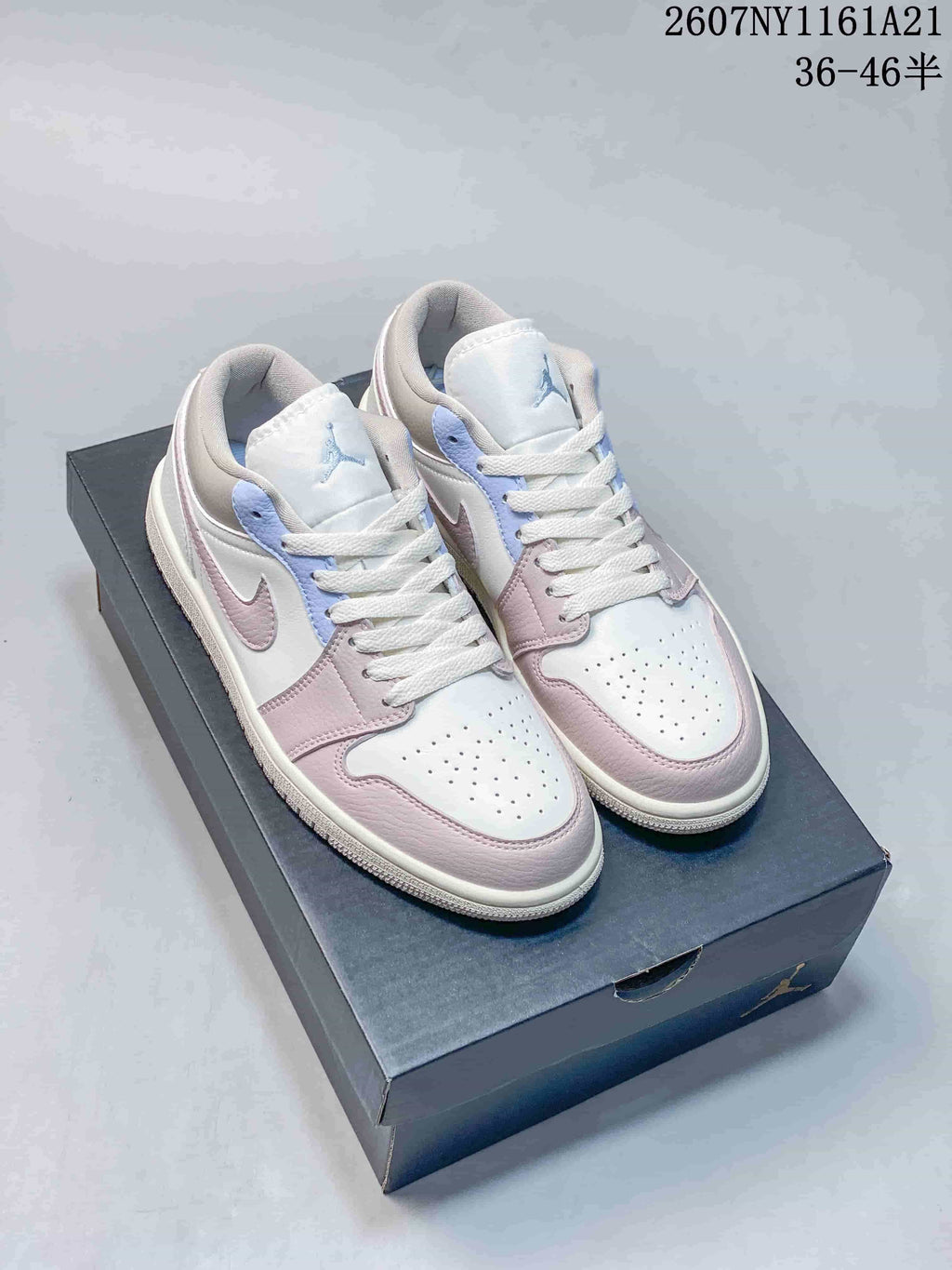 Pair of white, pink and light blue low-top Jordan sneakers displayed on a shoebox; image text shows style code 2607NY1161A21 and size range 36–46.5.