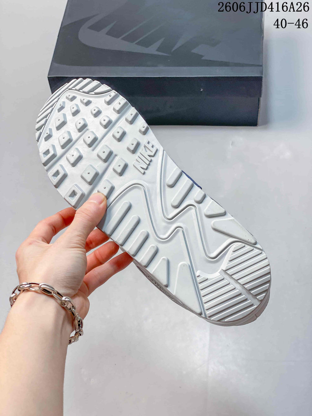Underside view of a white sneaker showing the raised patterned outsole and Nike branding.