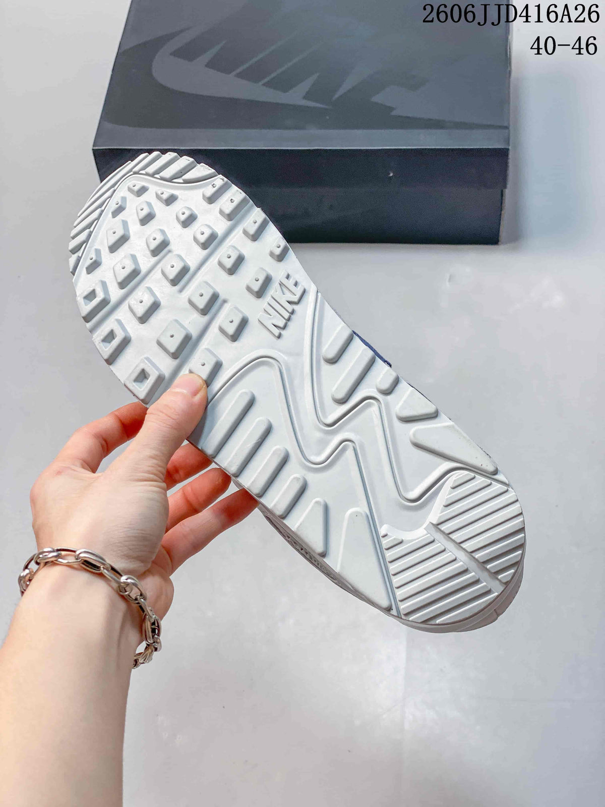 Underside view of a white sneaker showing the raised patterned outsole and Nike branding.