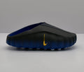 Side view of black and royal blue Nike slides with a gold Swoosh.