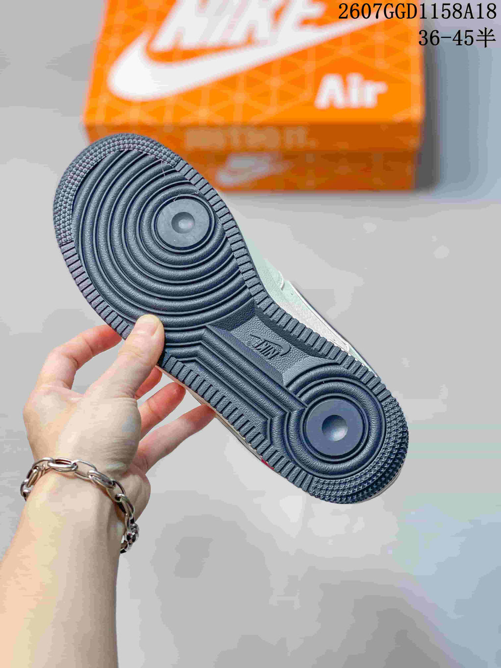 Close-up of the dark textured outsole with concentric circular traction zones and visible Nike branding.