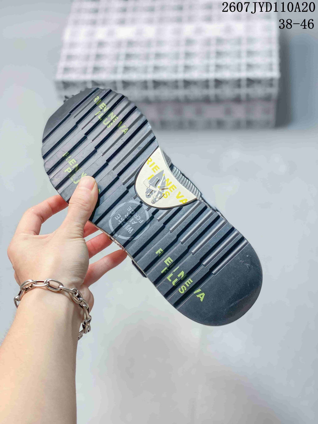 Underside view of a Premiata sneaker showing the ribbed black outsole and printed graphics.