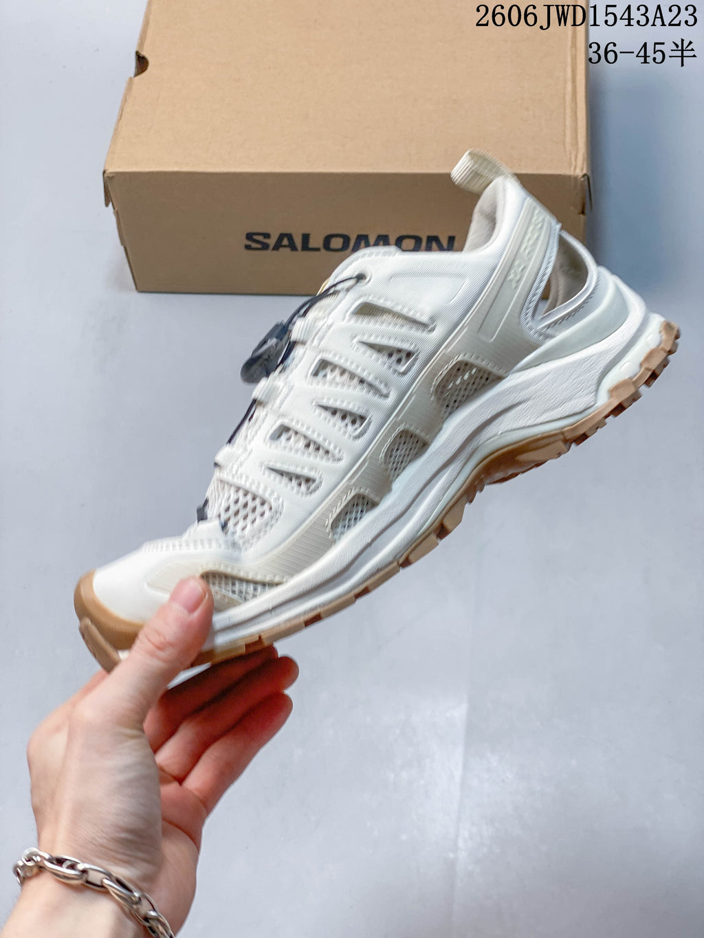 Side profile of an ivory sneaker with mesh panels and quick laces