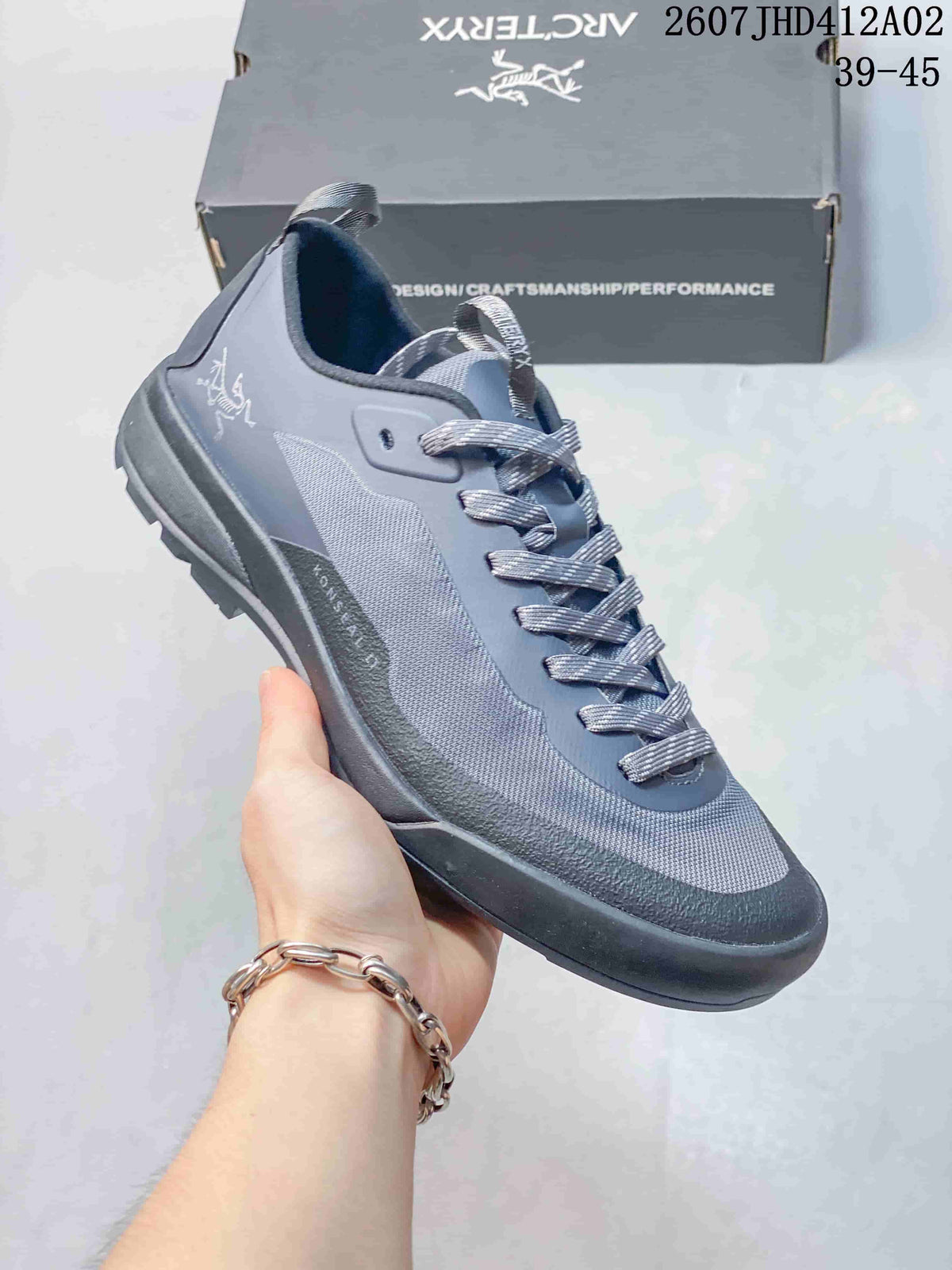 Gray Arc'teryx Konseal LT W shoe with dark trim and lace-up closure.