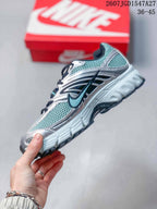 Side profile showing the layered silver and teal upper, black details, and chunky outsole.