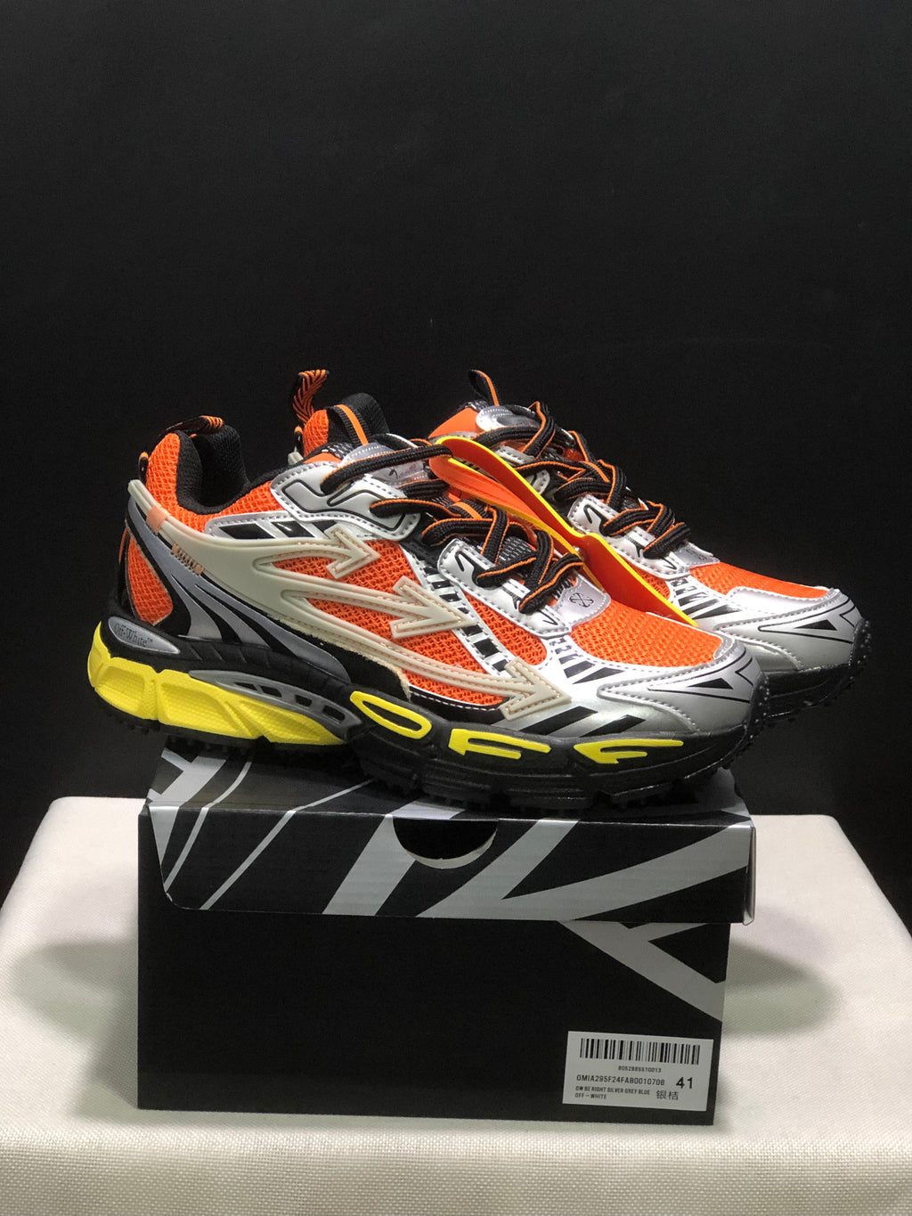 Pair of Off-White Be Right Back sneakers in orange, silver, black, and yellow displayed on a branded box.