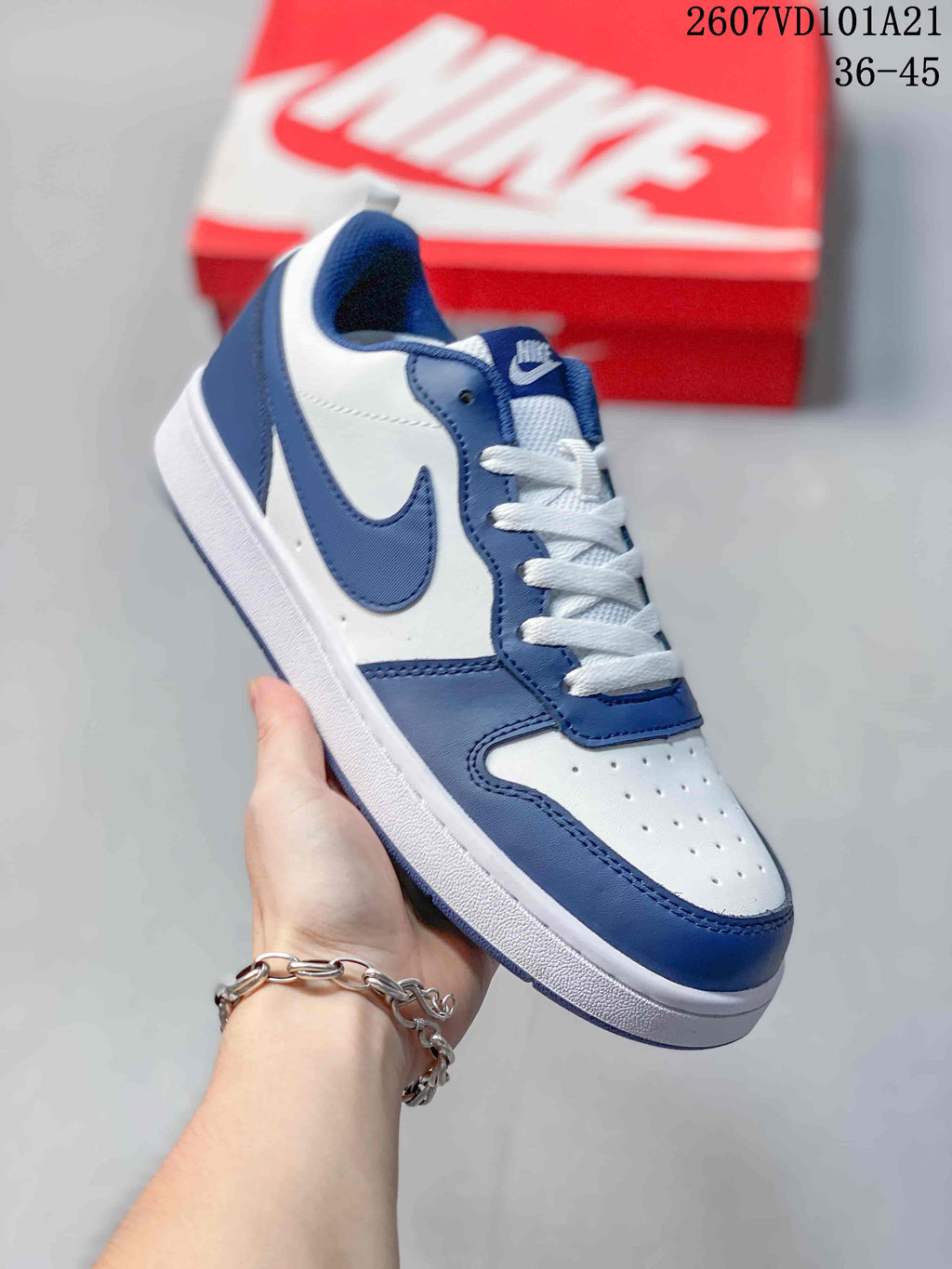White and blue Nike Court Borough BG sneaker with a navy Swoosh and matching overlays.