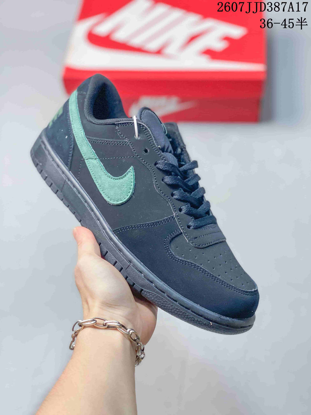 Angled side view highlighting the black upper, green Swoosh, and layered outsole.