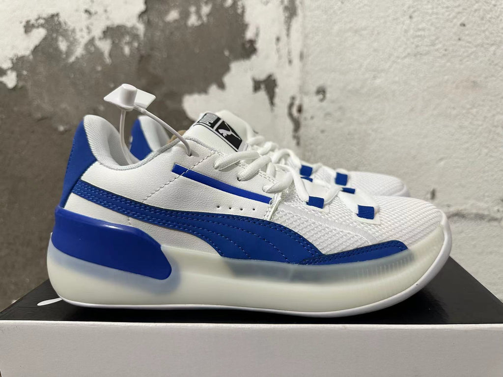 Side view of white Puma Clyde sneakers with blue stripes and a sculpted sole.