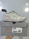 Beige and green Balenciaga Hamptons sneaker displayed on its box, with the product label visible.