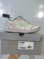 Beige and green Balenciaga Hamptons sneaker displayed on its box, with the product label visible.