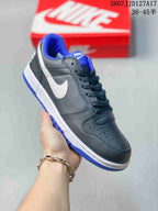 Black and white Nike SB Dunk Low Pro sneaker with bright blue collar, tongue, and outsole accents.