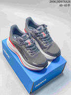 Pair of gray HOKA Bondi 9 shoes with white midsoles and red accents on a blue shoe box